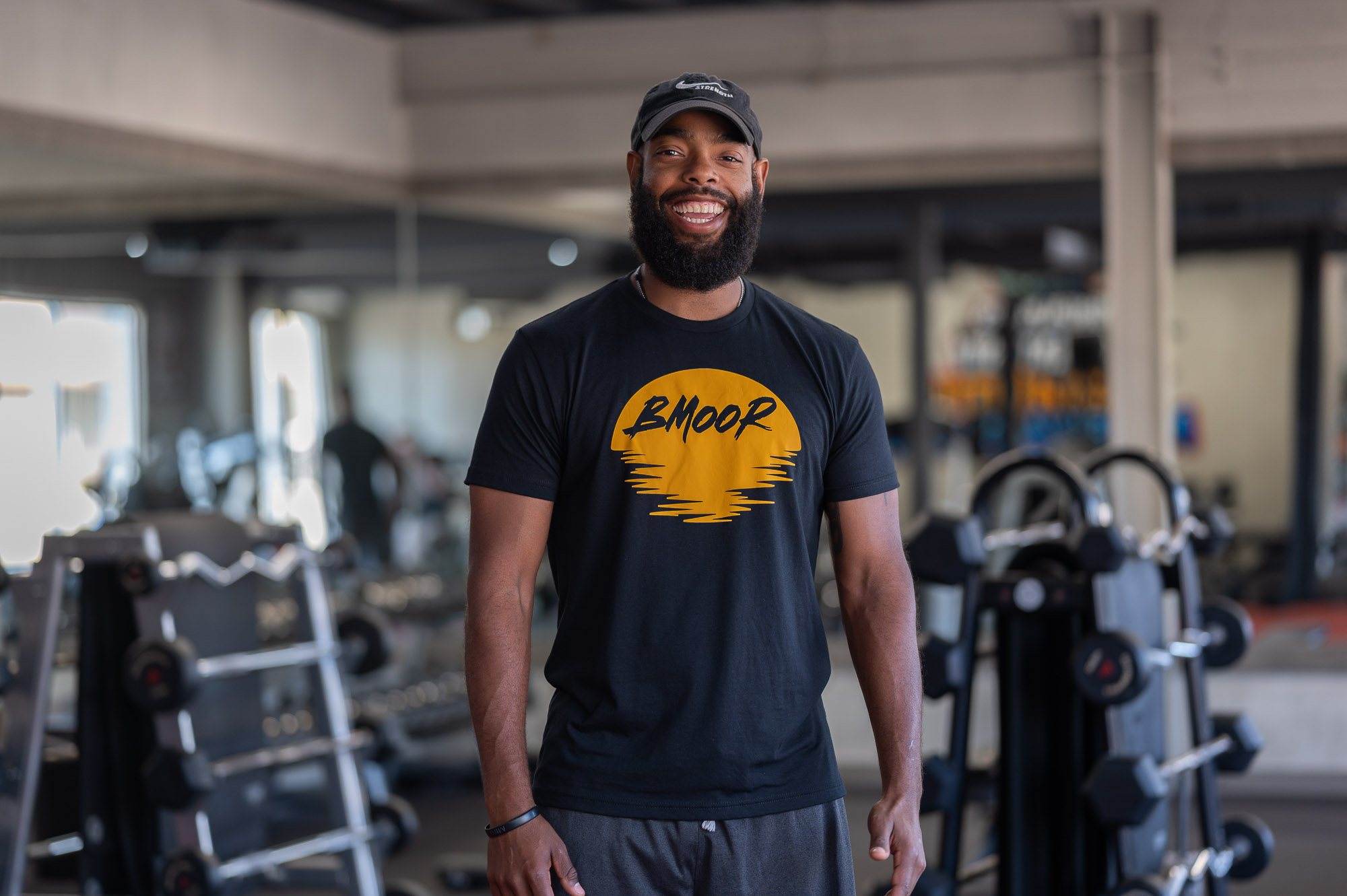 Man in a gym looking at the camera while smiling