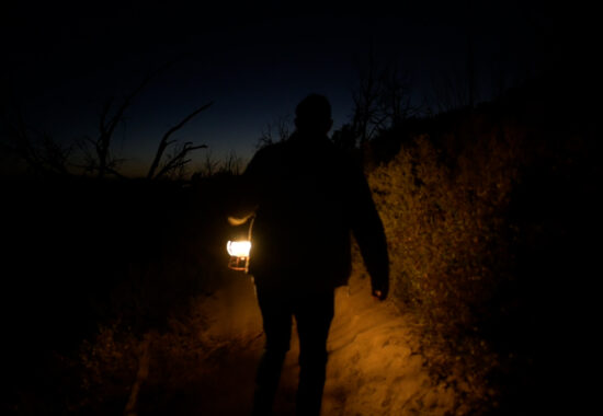Person walking while holding a lantern
